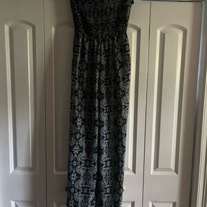 A strapless bodysuit with pockets that are wide leg never worn